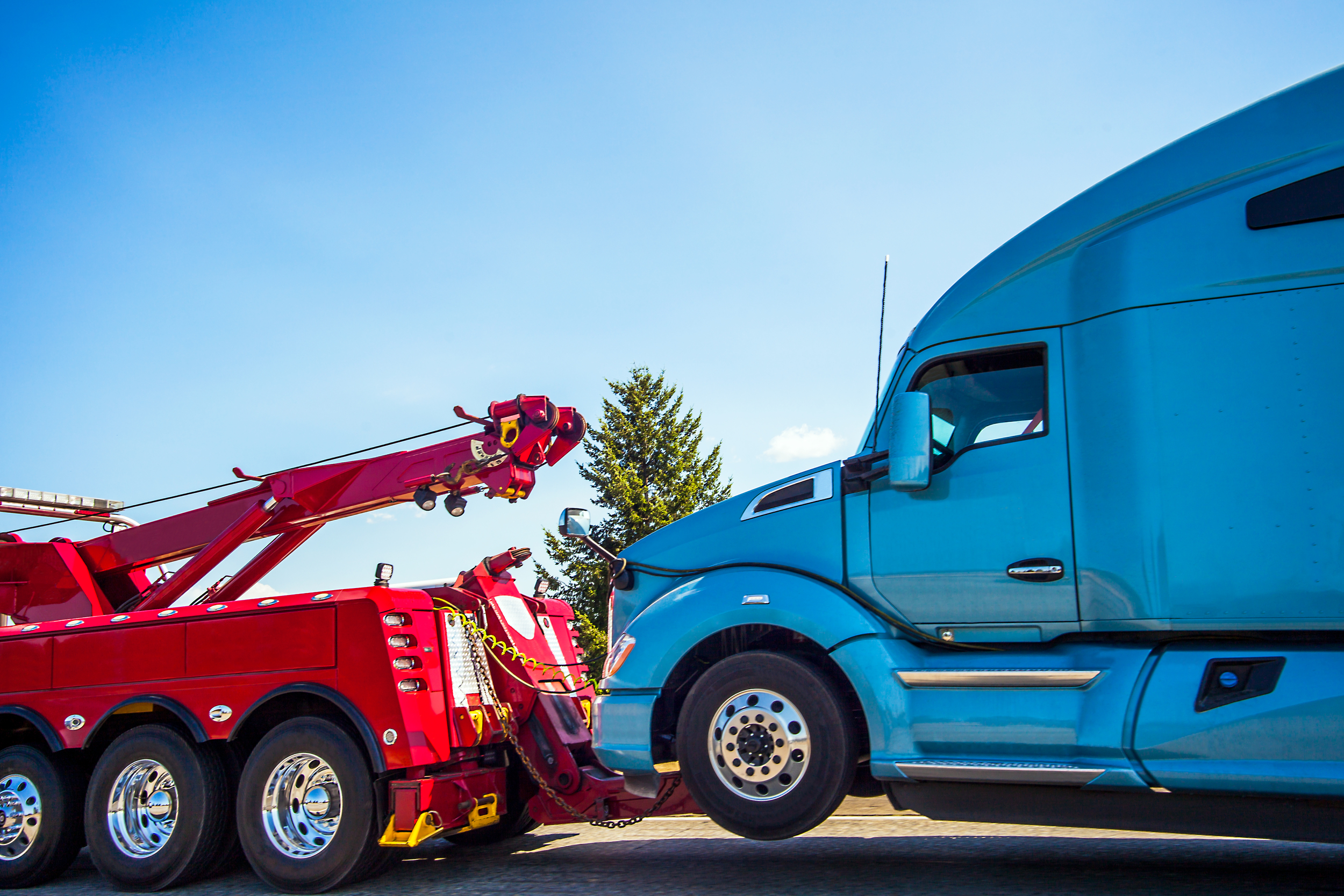 Tow truck towing 18 wheeler.